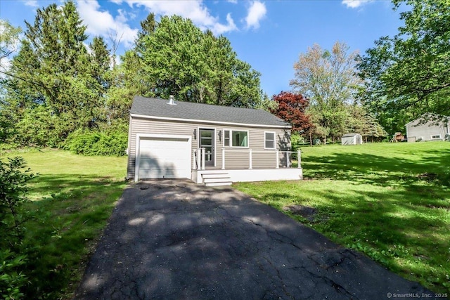 13 Turner Rd, Litchfield, CT 06778 - view of front of home with an attached garage, asphalt driveway, and a front yard