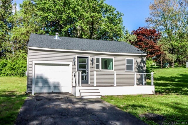 13 Turner Rd, Litchfield, CT 06778 - view of front of house with a front yard, asphalt driveway, a garage, and a shingled roof