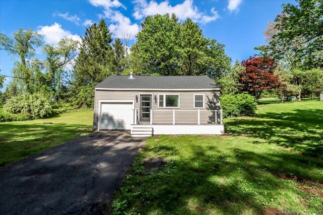 13 Turner Rd, Litchfield, CT 06778 - view of front facade featuring an attached garage, driveway, a front yard, and view of wooded area