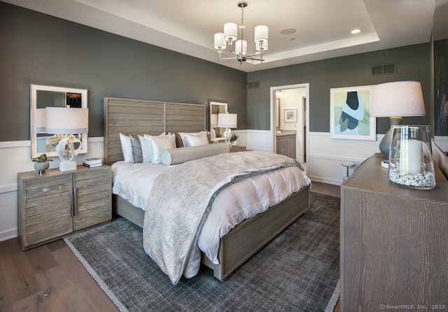 5 Heritage Ln Unit 68, Woodbridge, CT 06525 - bedroom with dark wood-type flooring, a chandelier, a raised ceiling, a wainscoted wall, and recessed lighting