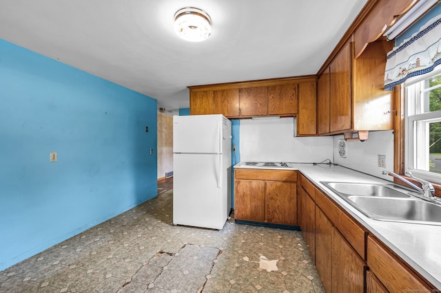 1 Pine Grove Ave, Enfield, CT 06082 - kitchen with white appliances, a sink, brown cabinetry, and light countertops