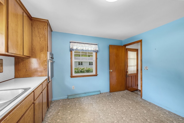 1 Pine Grove Ave, Enfield, CT 06082 - kitchen with baseboard heating, stainless steel oven, brown cabinetry, and a sink
