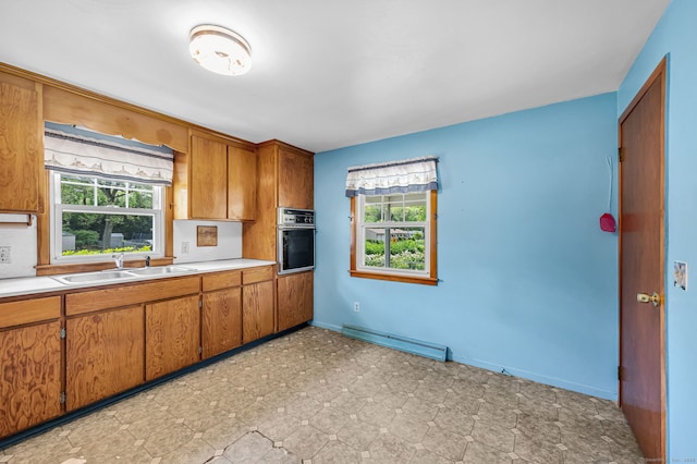 1 Pine Grove Ave, Enfield, CT 06082 - kitchen featuring oven, brown cabinetry, a sink, light countertops, and healthy amount of natural light