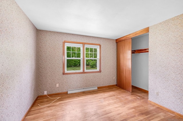 1 Pine Grove Ave, Enfield, CT 06082 - unfurnished bedroom with a baseboard heating unit, wood finished floors, wallpapered walls, and a closet