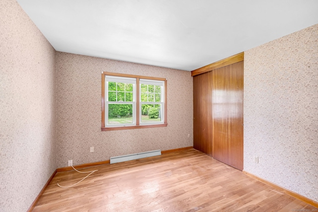 1 Pine Grove Ave, Enfield, CT 06082 - unfurnished bedroom with a baseboard radiator, wood finished floors, and wallpapered walls