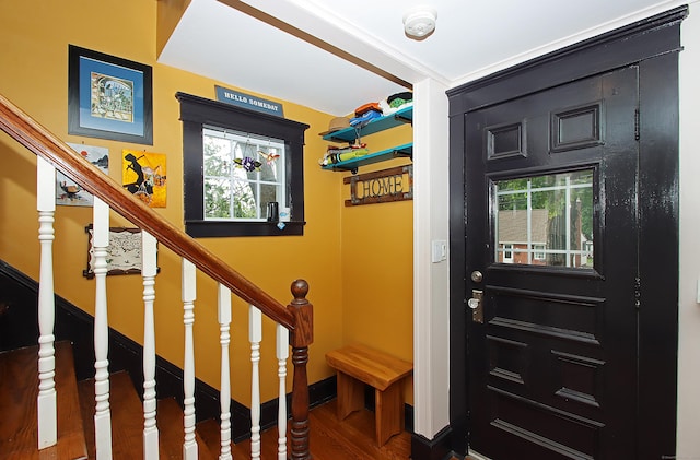 62 Mather St, Manchester, CT 06042 - foyer entrance with plenty of natural light, wood finished floors, stairs, and baseboards