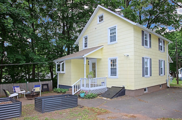 62 Mather St, Manchester, CT 06042 - rear view of property featuring a patio area, an outdoor fire pit, and a shingled roof