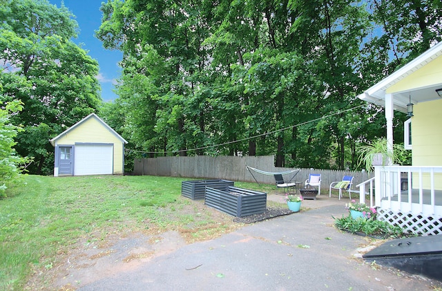 62 Mather St, Manchester, CT 06042 - view of yard featuring a garage, an outbuilding, driveway, and view of wooded area