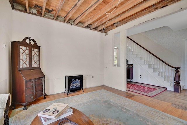 29 Walnut St, Winchester, CT 06098 - living room with wood finished floors, stairway, and a wood stove