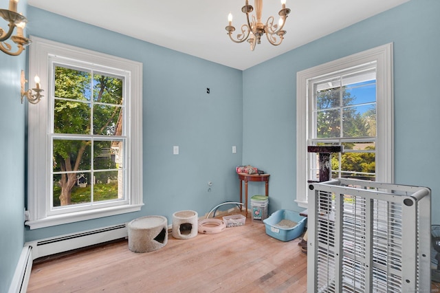 29 Walnut St, Winchester, CT 06098 - dining area featuring a chandelier, wood finished floors, and a baseboard heating unit