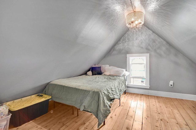 29 Walnut St, Winchester, CT 06098 - bedroom featuring wood-type flooring, baseboards, lofted ceiling, and a chandelier