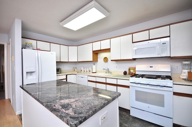 443 S Main St Unit 34, Manchester, CT 06040 - kitchen with white appliances, a sink, white cabinetry, a kitchen island, and dark countertops