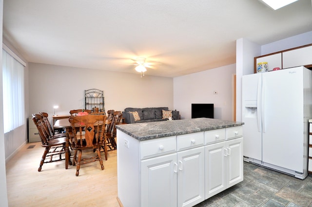 443 S Main St Unit 34, Manchester, CT 06040 - kitchen featuring white fridge with ice dispenser, a kitchen island, white cabinets, and a ceiling fan