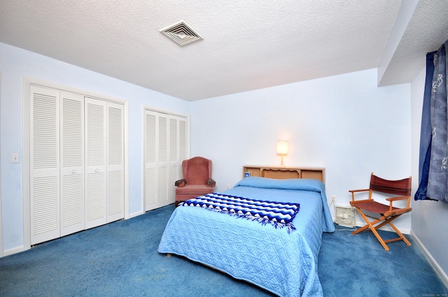 443 S Main St Unit 34, Manchester, CT 06040 - carpeted bedroom featuring multiple closets, baseboards, and a textured ceiling