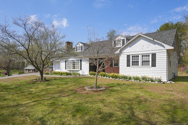870 N Colony Rd, Meriden, CT 06450 - view of front of house with a garage, a front lawn, a chimney, and roof with shingles