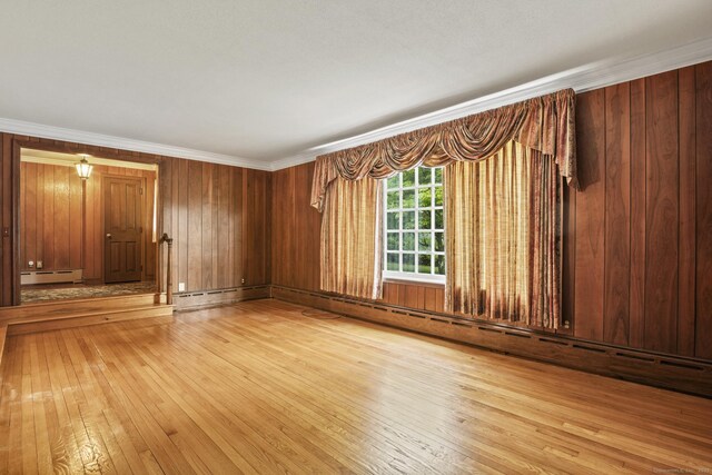 870 N Colony Rd, Meriden, CT 06450 - unfurnished room featuring a baseboard heating unit, light wood-type flooring, wood walls, and ornamental molding