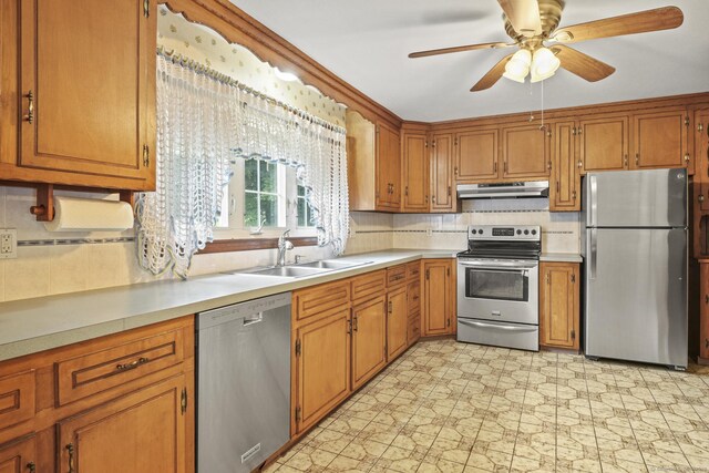 870 N Colony Rd, Meriden, CT 06450 - kitchen featuring stainless steel appliances, under cabinet range hood, a sink, brown cabinetry, and tasteful backsplash