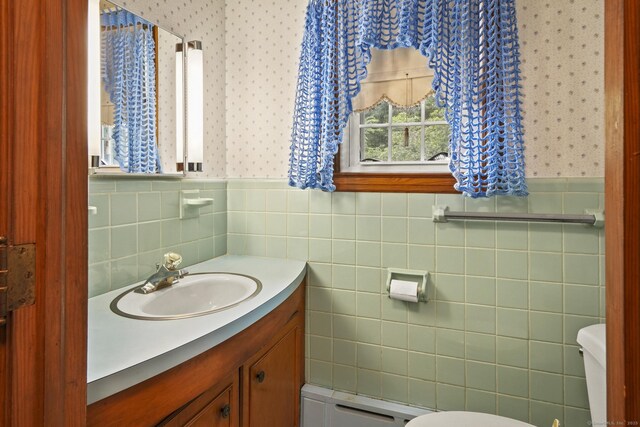 870 N Colony Rd, Meriden, CT 06450 - half bath featuring wallpapered walls, toilet, vanity, wainscoting, and baseboard heating