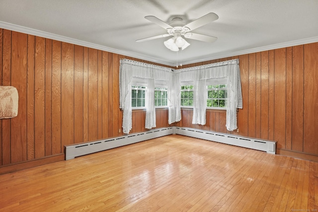 870 N Colony Rd, Meriden, CT 06450 - unfurnished room featuring wood-type flooring, ceiling fan, crown molding, a baseboard radiator, and wood walls