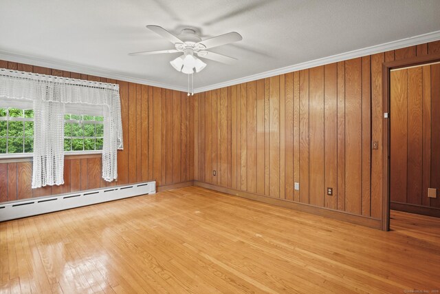 870 N Colony Rd, Meriden, CT 06450 - spare room with baseboard heating, hardwood / wood-style floors, ceiling fan, ornamental molding, and wooden walls