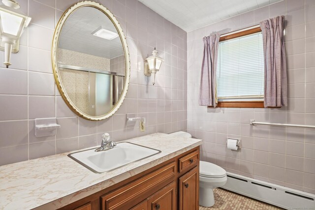 870 N Colony Rd, Meriden, CT 06450 - bathroom featuring baseboard heating, vanity, toilet, tile walls, and tile patterned floors