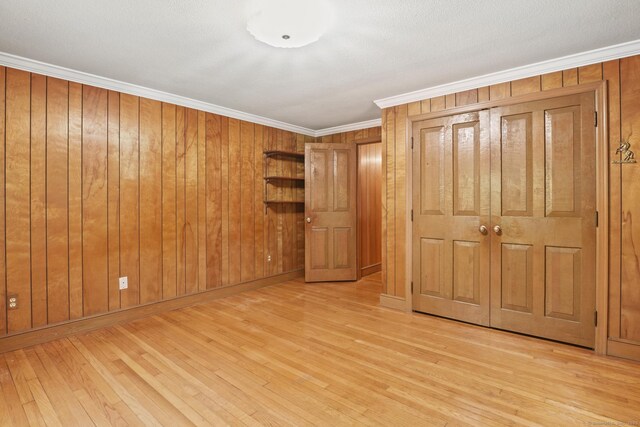 870 N Colony Rd, Meriden, CT 06450 - unfurnished bedroom with wood finished floors, crown molding, baseboards, and wooden walls