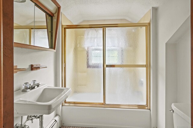 870 N Colony Rd, Meriden, CT 06450 - bathroom featuring toilet, vaulted ceiling, combined bath / shower with glass door, and a textured ceiling