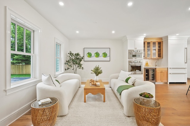 181 Highland Ave, Norwalk, CT 06853 - living room featuring wet bar, recessed lighting, light wood finished floors, and beverage cooler