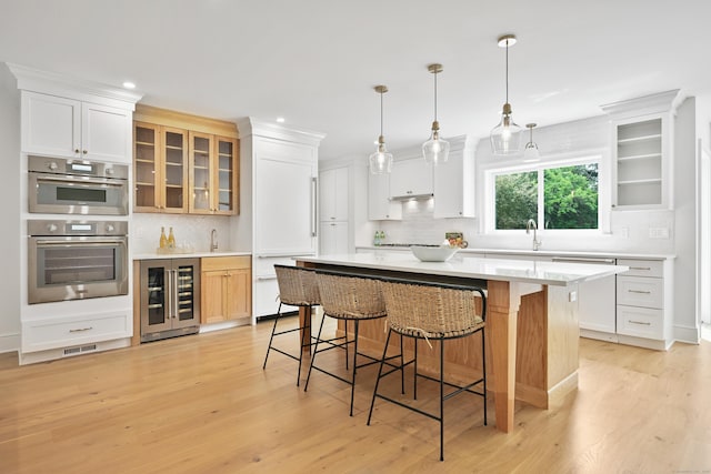 181 Highland Ave, Norwalk, CT 06853 - kitchen with beverage cooler, a kitchen bar, tasteful backsplash, and recessed lighting