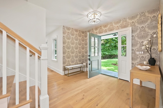 181 Highland Ave, Norwalk, CT 06853 - entryway with wallpapered walls, stairway, light wood-style flooring, and healthy amount of natural light