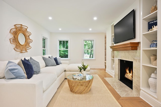 181 Highland Ave, Norwalk, CT 06853 - living area featuring a high end fireplace, recessed lighting, built in shelves, and light wood-style floors