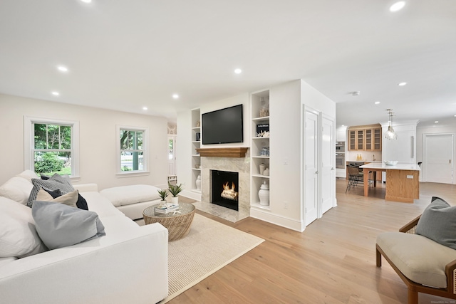 181 Highland Ave, Norwalk, CT 06853 - living area with a high end fireplace, recessed lighting, light wood-style flooring, and built in features
