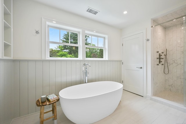 181 Highland Ave, Norwalk, CT 06853 - full bath with a wainscoted wall, a tile shower, and a freestanding bath