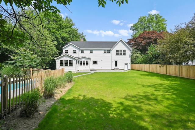 181 Highland Ave, Norwalk, CT 06853 - rear view of property with a patio area, a fenced backyard, and a chimney