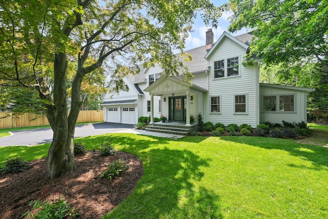 181 Highland Ave, Norwalk, CT 06853 - view of front facade with board and batten siding, driveway, a shingled roof, a chimney, and a garage