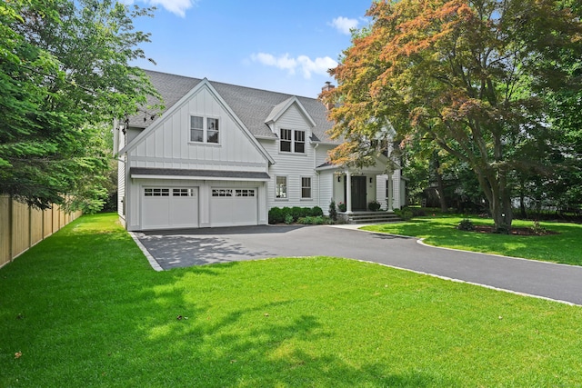 181 Highland Ave, Norwalk, CT 06853 - view of front of house featuring board and batten siding, a shingled roof, driveway, and an attached garage