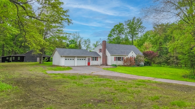 46 Newberry Rd, East Windsor, CT 06088 - view of front of home featuring a chimney, driveway, a front yard, and an attached garage