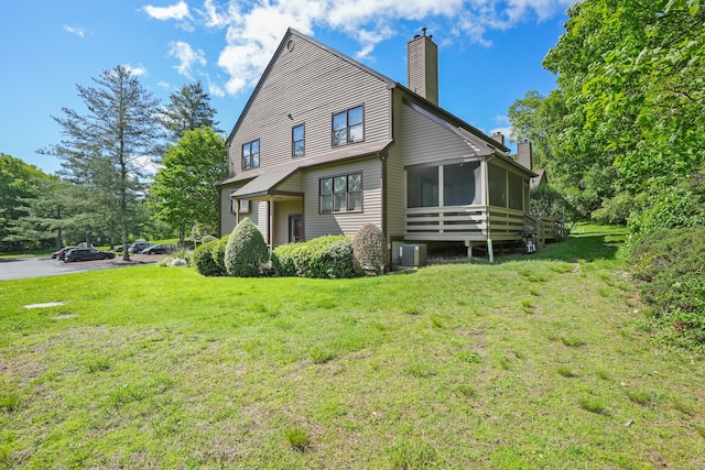 17 Hollow Tree Ln Unit 17, Monroe, CT 06468 - back of house with a chimney, a sunroom, a lawn, and central air condition unit