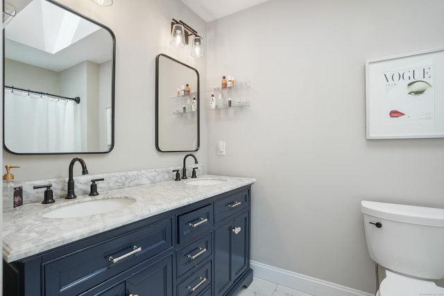 17 Hollow Tree Ln Unit 17, Monroe, CT 06468 - full bath with double vanity, toilet, baseboards, and a skylight