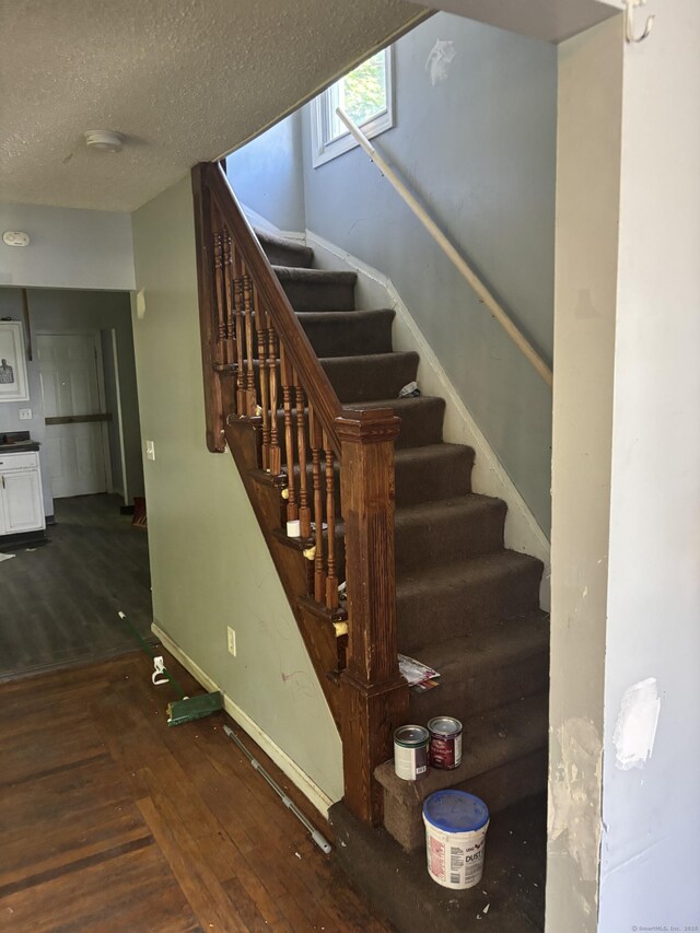 14 Judson Ave, New Haven, CT 06511 - stairs with wood finished floors and a textured ceiling