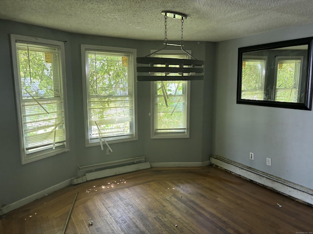 14 Judson Ave, New Haven, CT 06511 - unfurnished dining area featuring a baseboard heating unit, wood-type flooring, and a textured ceiling