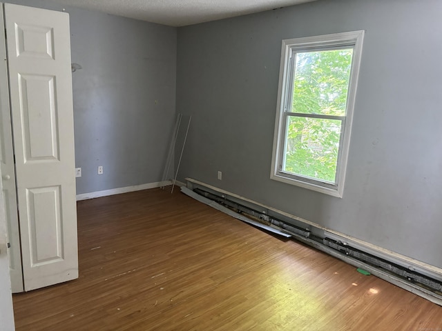 14 Judson Ave, New Haven, CT 06511 - spare room featuring wood finished floors and a baseboard heating unit