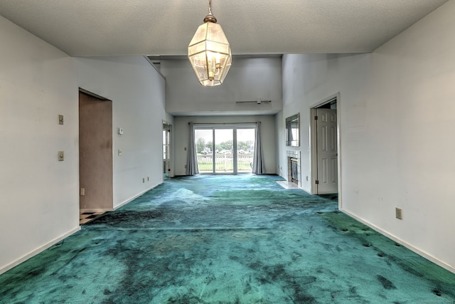 74 Quarry Dock Rd Unit 74, Branford, CT 06405 - unfurnished living room featuring carpet floors, baseboards, a chandelier, and vaulted ceiling