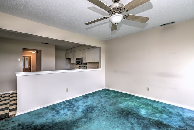 74 Quarry Dock Rd Unit 74, Branford, CT 06405 - kitchen with stainless steel microwave, a peninsula, gray cabinetry, baseboards, and ceiling fan