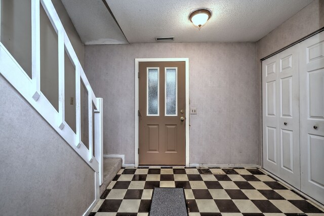 74 Quarry Dock Rd Unit 74, Branford, CT 06405 - entrance foyer with tile patterned floors, a textured ceiling, and stairway