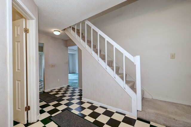 74 Quarry Dock Rd Unit 74, Branford, CT 06405 - stairway featuring tile patterned floors, a textured ceiling, and baseboards