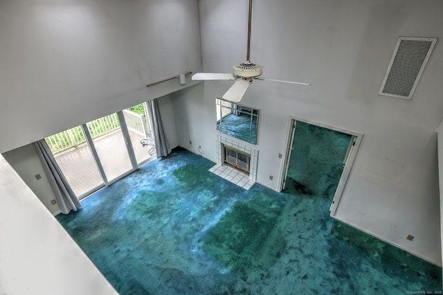 74 Quarry Dock Rd Unit 74, Branford, CT 06405 - unfurnished living room with a ceiling fan, a high ceiling, carpet flooring, and a tile fireplace