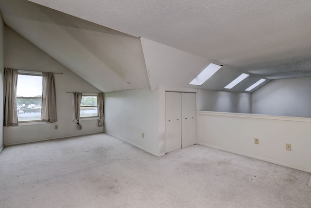 74 Quarry Dock Rd Unit 74, Branford, CT 06405 - bonus room with a skylight, lofted ceiling, carpet, baseboards, and a textured ceiling