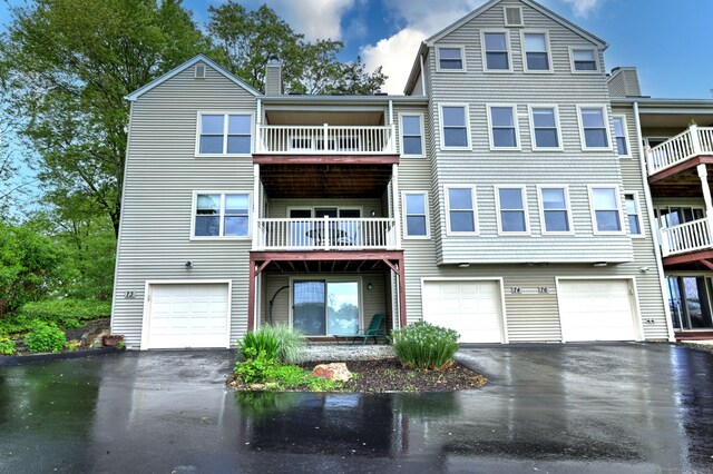 74 Quarry Dock Rd Unit 74, Branford, CT 06405 - view of front facade with driveway, an attached garage, a chimney, and a balcony