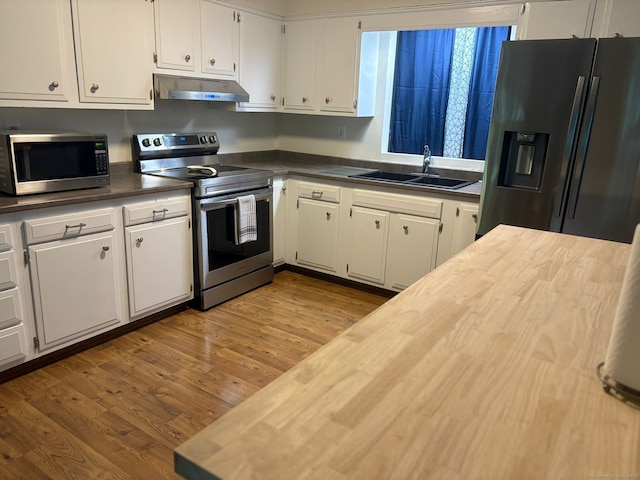 11 Arden Ave, New Fairfield, CT 06812 - kitchen featuring stainless steel appliances, a sink, under cabinet range hood, white cabinetry, and wooden counters